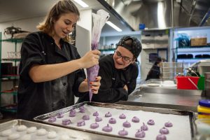 Hand-made frosting squeezed out just so in our pastry school.
